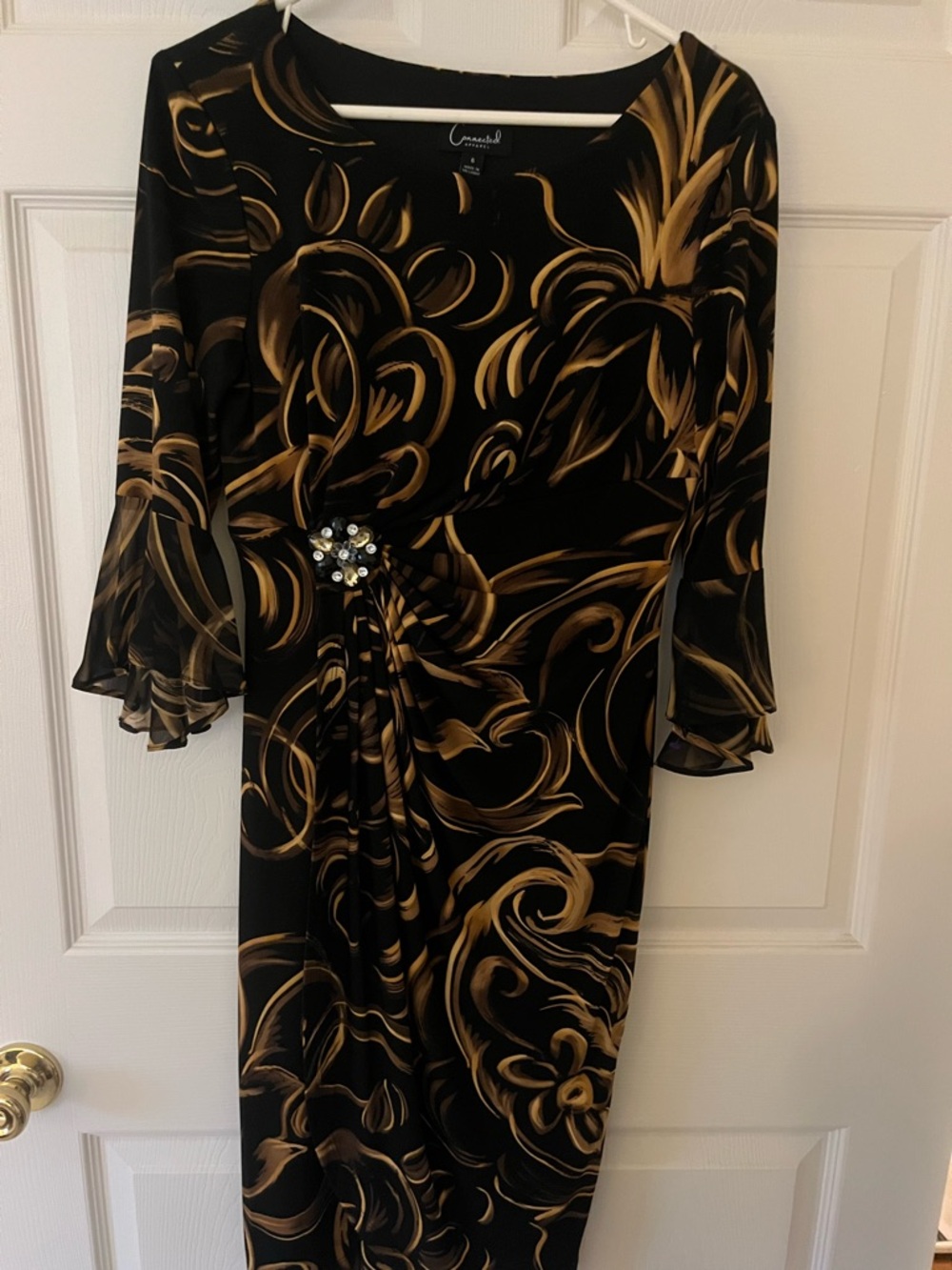 connected apparel Black Dress with Gold Swirl Print and Brooch